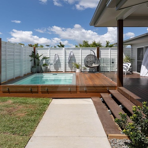 Modern pool with wooden deck.